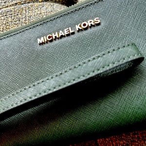 Michael Kors wristlet wallet. Fabric is a durable leather. Green. NWOT unused.
